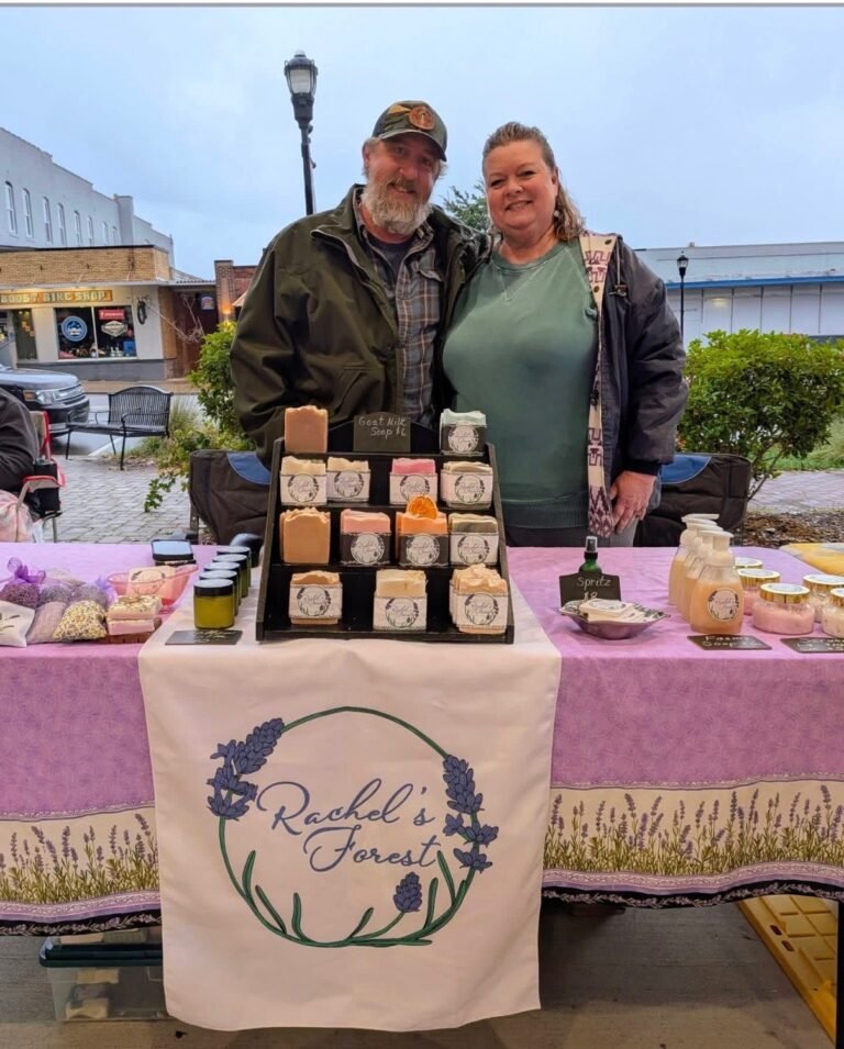 Owners of Rachels Forest standing at a market booth